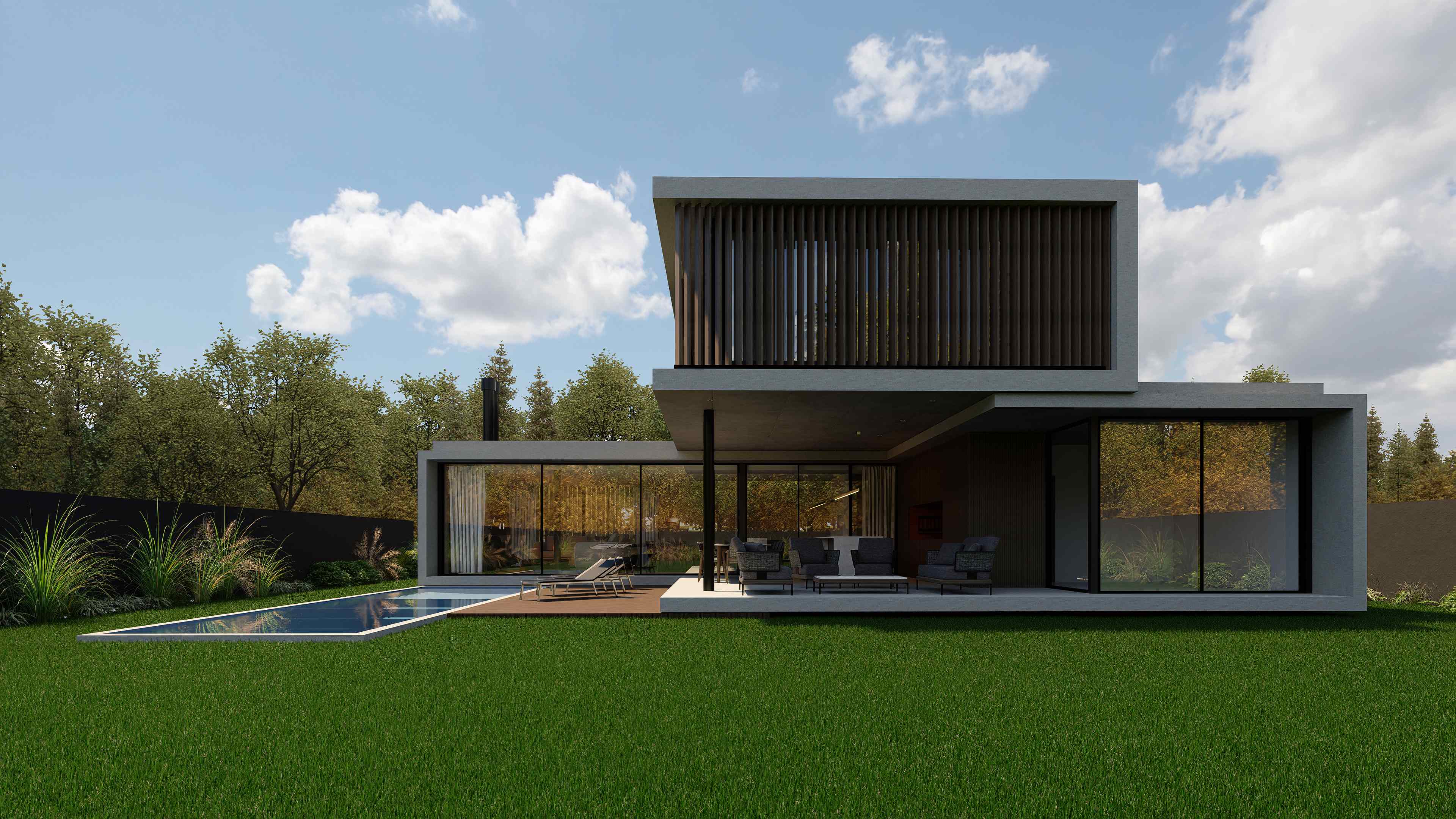 Vista posterior de día mostrando la relación con el jardín y la volumetría completa